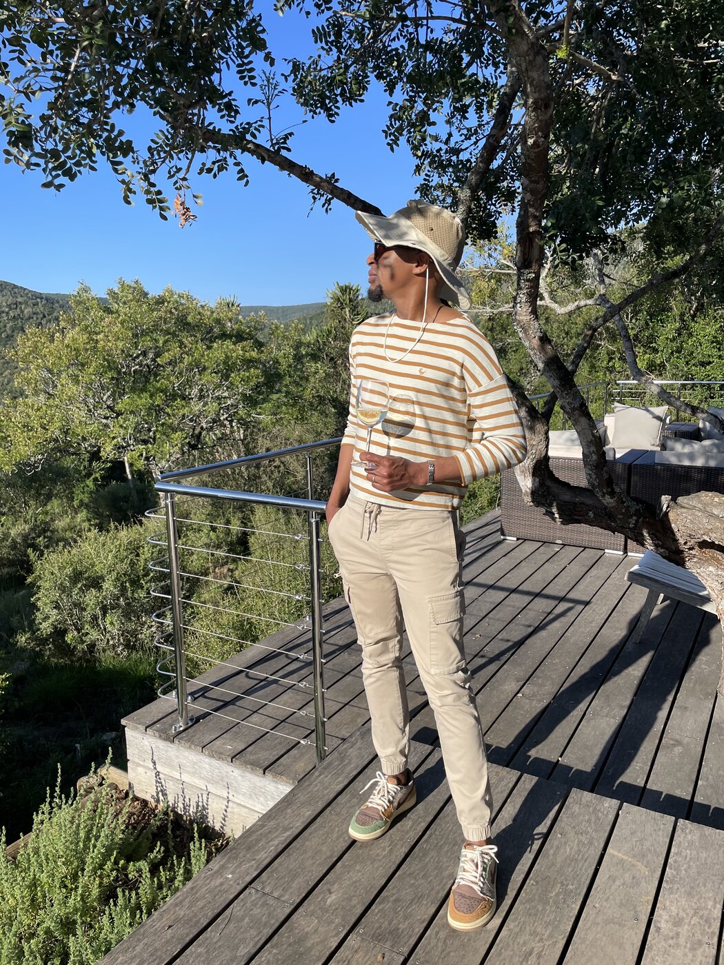 One of the founders enjoying a glass of wine on the Settlers Drift deck at golden hour