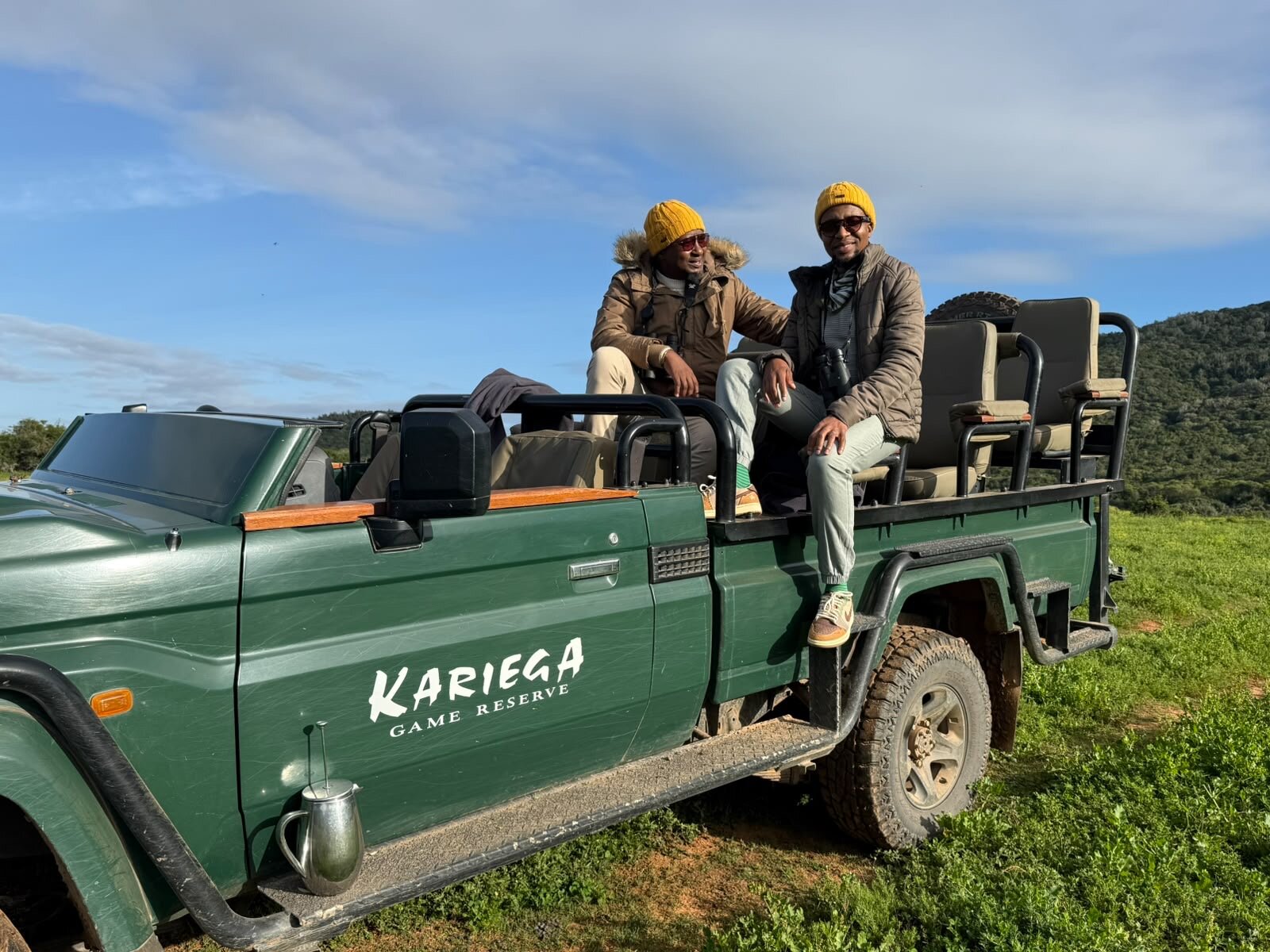 Bakubung Safaris founders Thabo and Katlego on the Kariega Game Reserve safari vehicle with binoculars